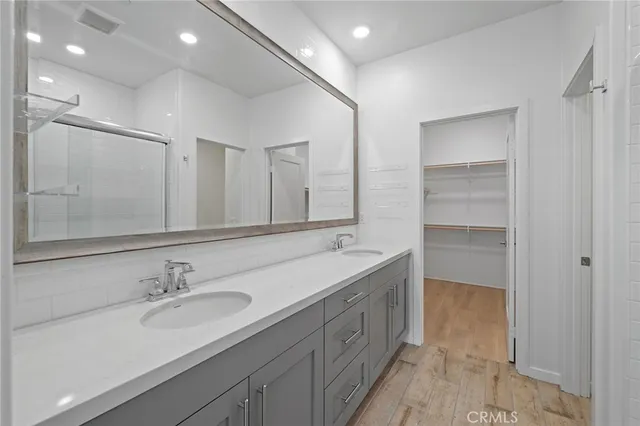 a bathroom with a double vanity sink and a mirror