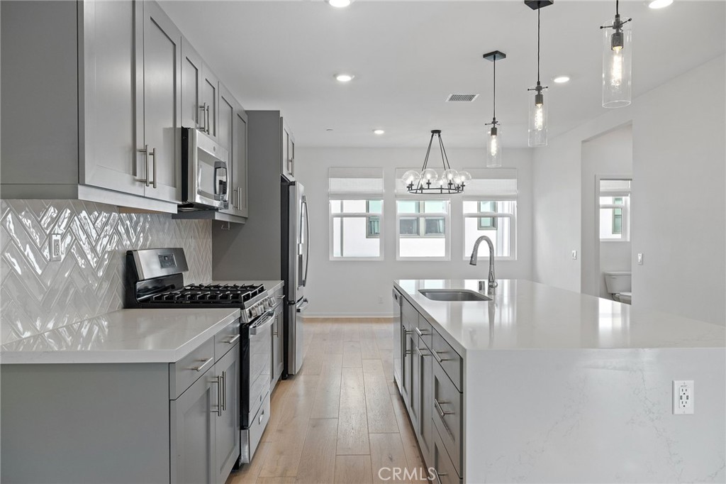 712 South Grable Circle Orange, CA 92868 - Photo 5 of 42 a kitchen with stainless steel appliances granite countertop a sink stove and cabinets