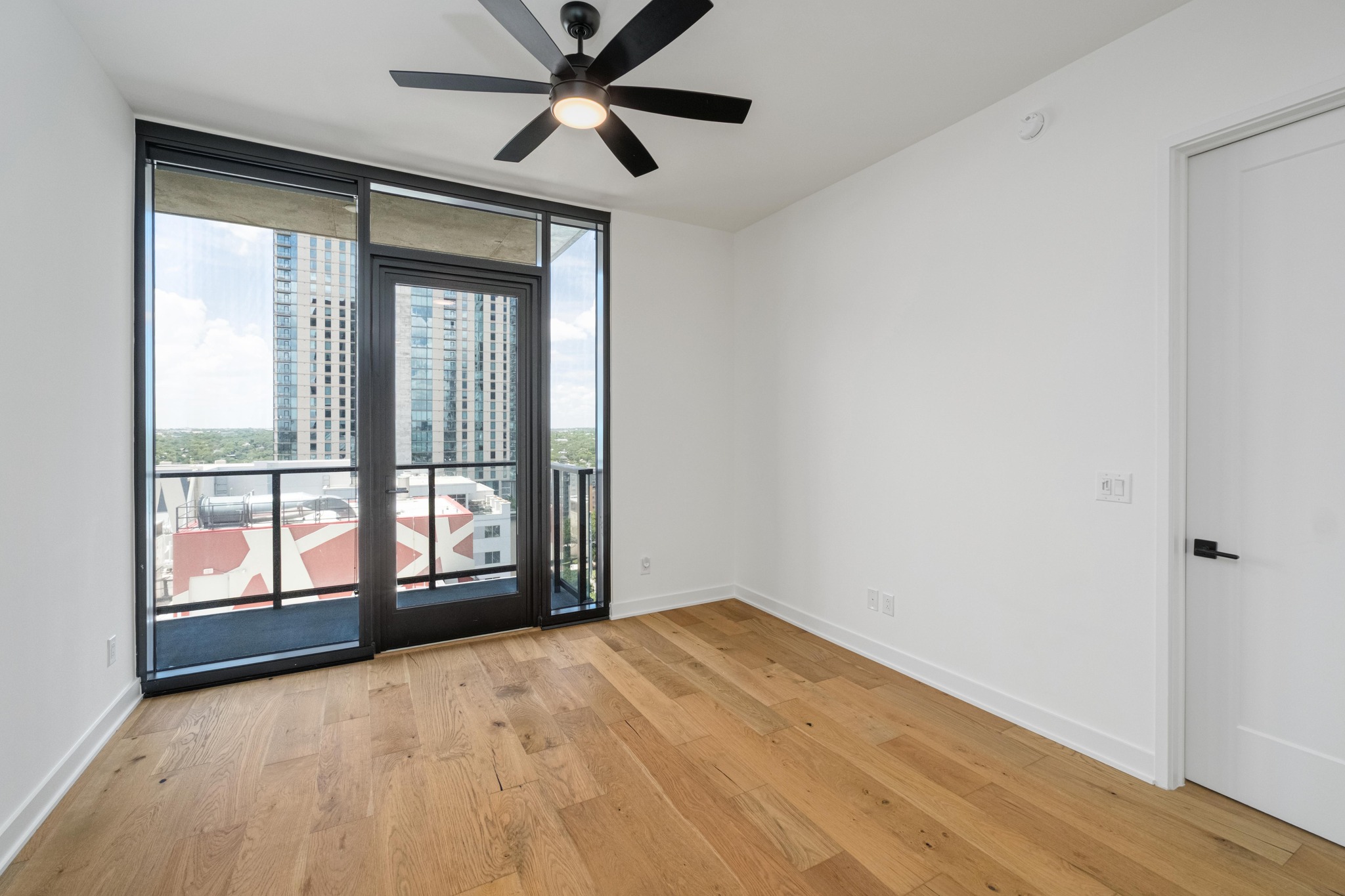 84 East Avenue, Unit 2008 Austin, TX 78701 - Photo 10 of 23 City views from the living room featuring hardwood floors and a ceiling fan.