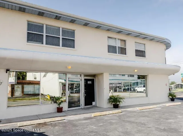 a front view of a building with glass windows and door