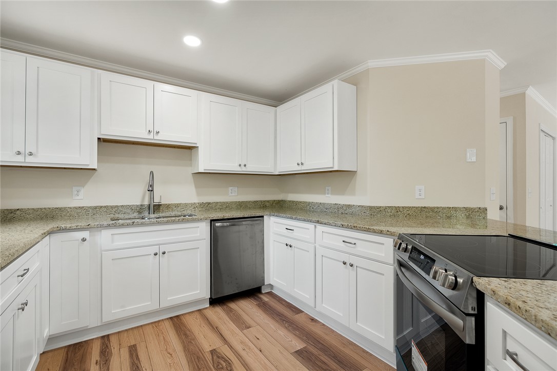 131 Lockaby Road Pelzer, SC 29669 - Photo 20 of 50 This modern kitchen features crisp white cabinetry and durable countertops, perfect for culinary adventures.