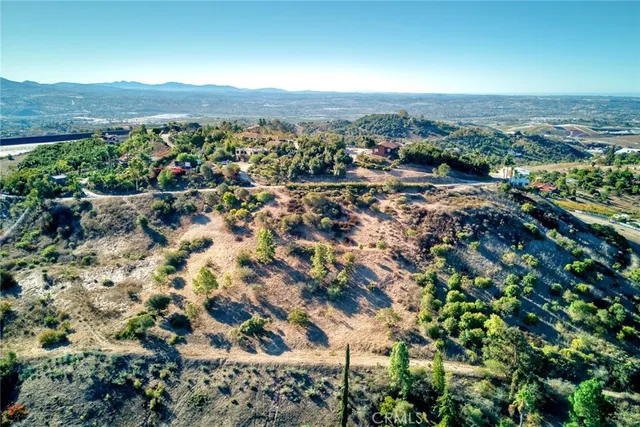 an aerial view of residential house with outdoor space and trees around