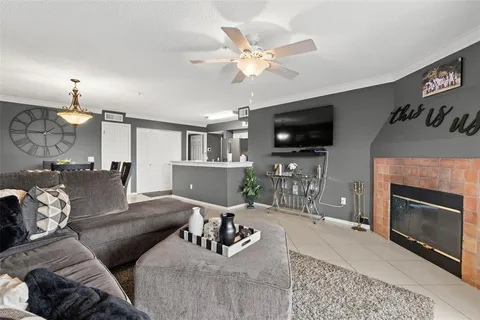 a living room with furniture a flat screen tv and a fireplace