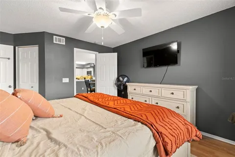 a bedroom with a bed and a flat screen tv