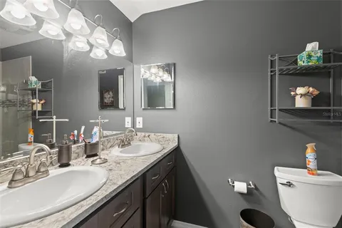 a bathroom with a sink vanity and a mirror