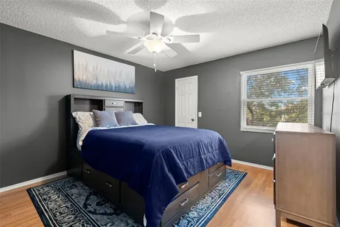 a bedroom with a large bed and a chandelier