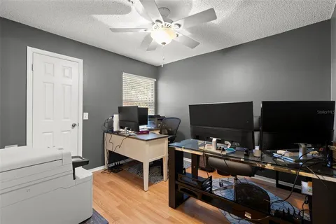 a work room with furniture and a flat screen tv