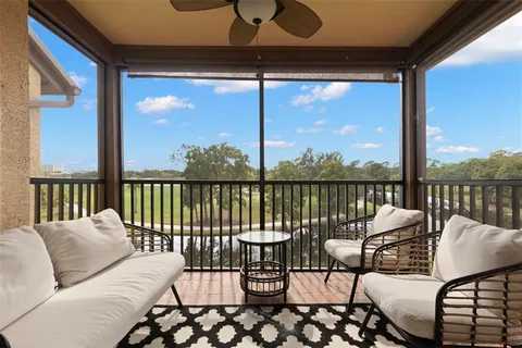 a balcony with furniture and view of a lake