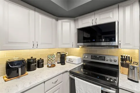 a kitchen with a stove and a microwave