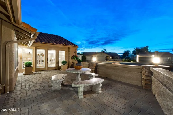 a view of a house with a big yard and palm trees
