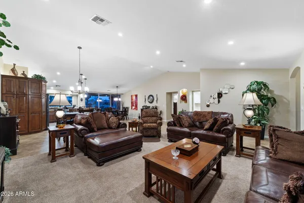 a living room with lots of furniture and painting on the wall
