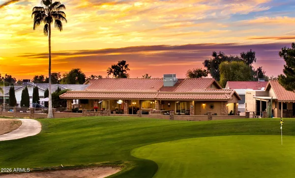 a view of a swimming pool with a table and chairs under an umbrella