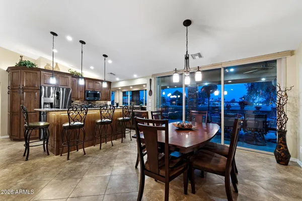 a kitchen with stainless steel appliances kitchen island granite countertop a sink and cabinets