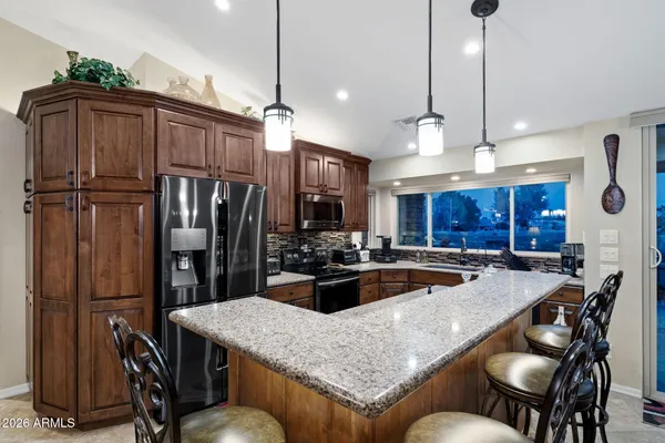 a living room with lots of furniture and view of kitchen