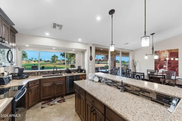 a living room with lots of furniture and a large window