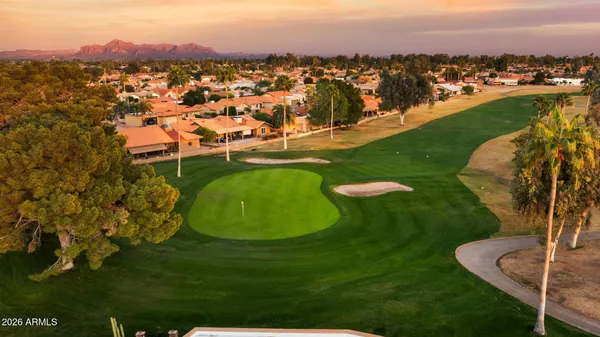 a front view of a house with patio outdoor seating and a potted plant