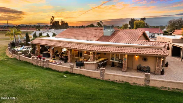 a kitchen with stainless steel appliances kitchen island granite countertop a sink stove and refrigerator