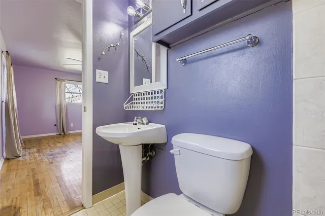 a white toilet sitting next to a bathroom sink