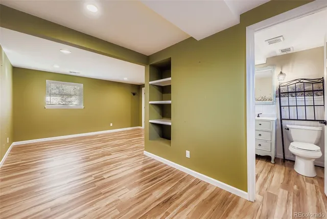 a view of a room with wooden floor and bathroom