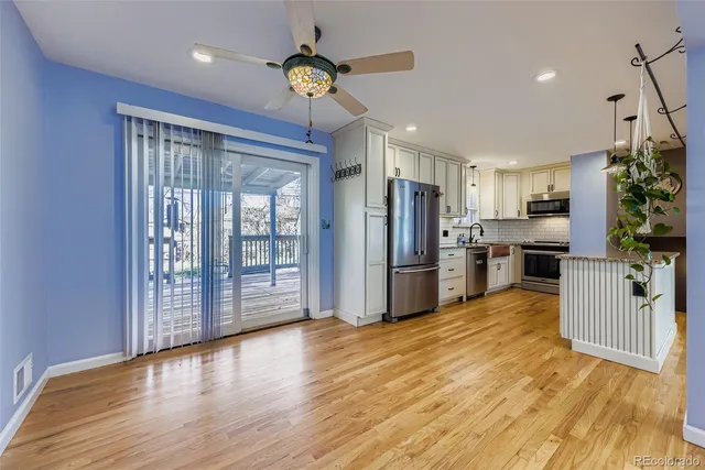 a view of kitchen with stainless steel appliances granite countertop a refrigerator oven a sink dishwasher and a refrigerator