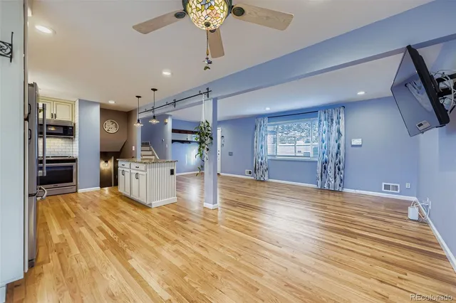 a view of a kitchen with microwave and refrigerator