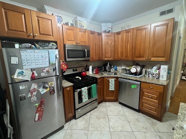 a kitchen with stainless steel appliances granite countertop a stove top oven a sink dishwasher and cabinets