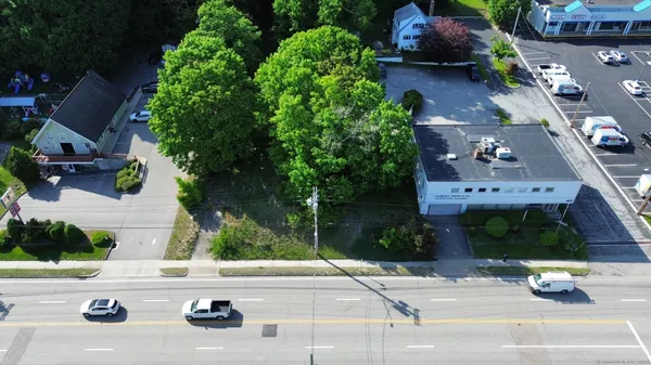 an aerial view of a house with garden space and street view