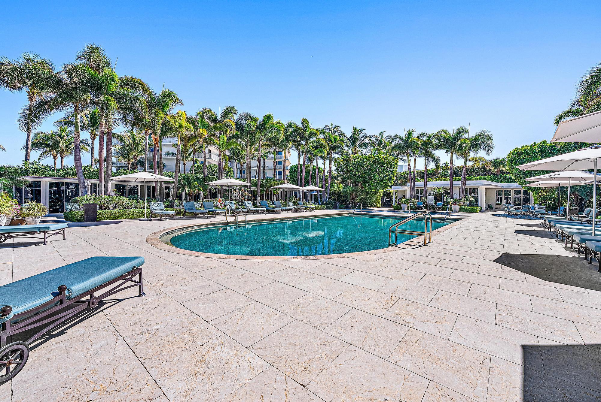 2500 South Ocean Boulevard, Unit 1 D 2 Palm Beach, FL 33480 - Photo 26 of 42 a view of a swimming pool with lawn chairs and a fire pit