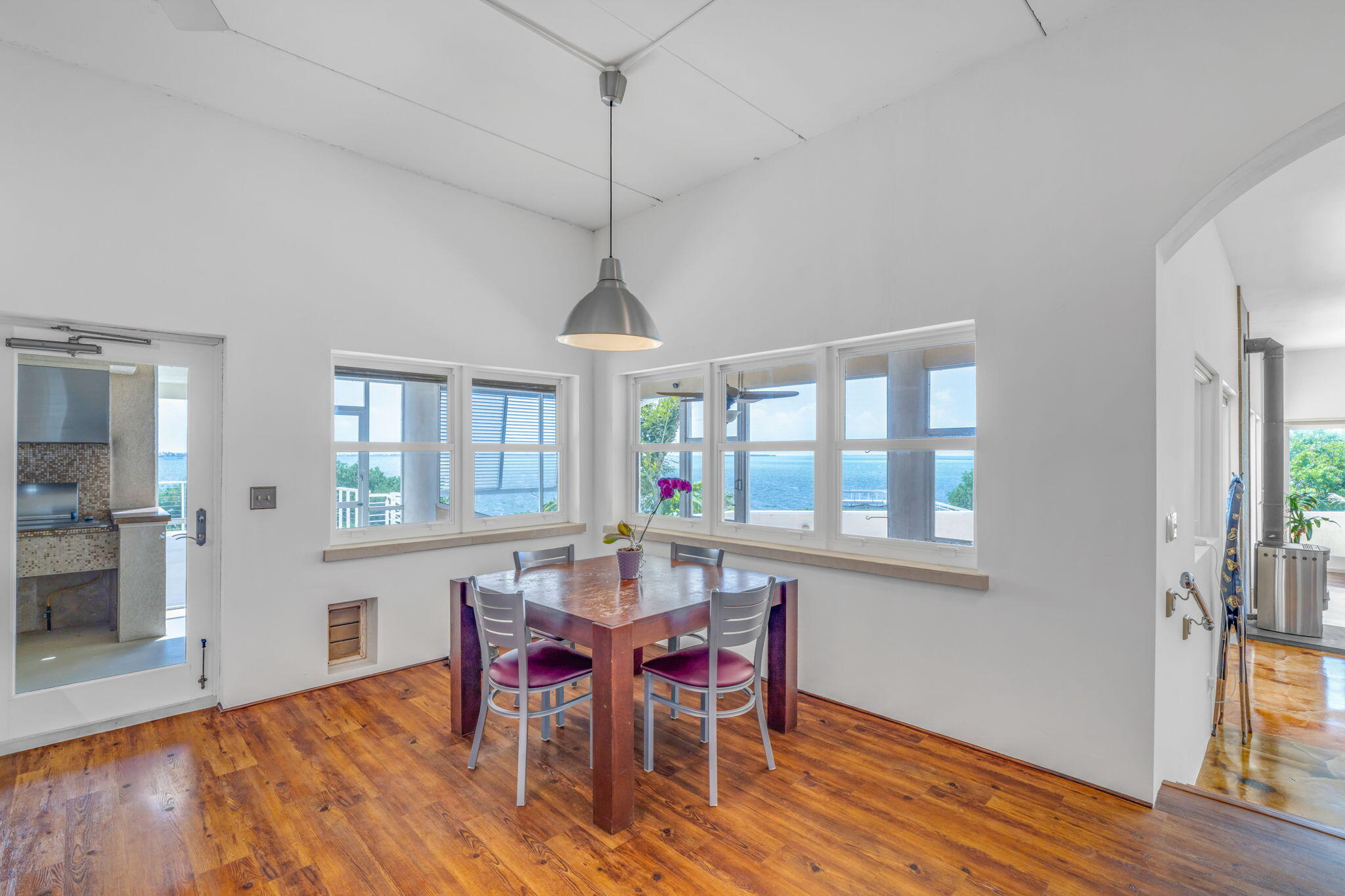 225 Colson Drive Cudjoe, FL 33042 - Photo 12 of 71 a dining room with wooden floor a chandelier a wooden table and chairs