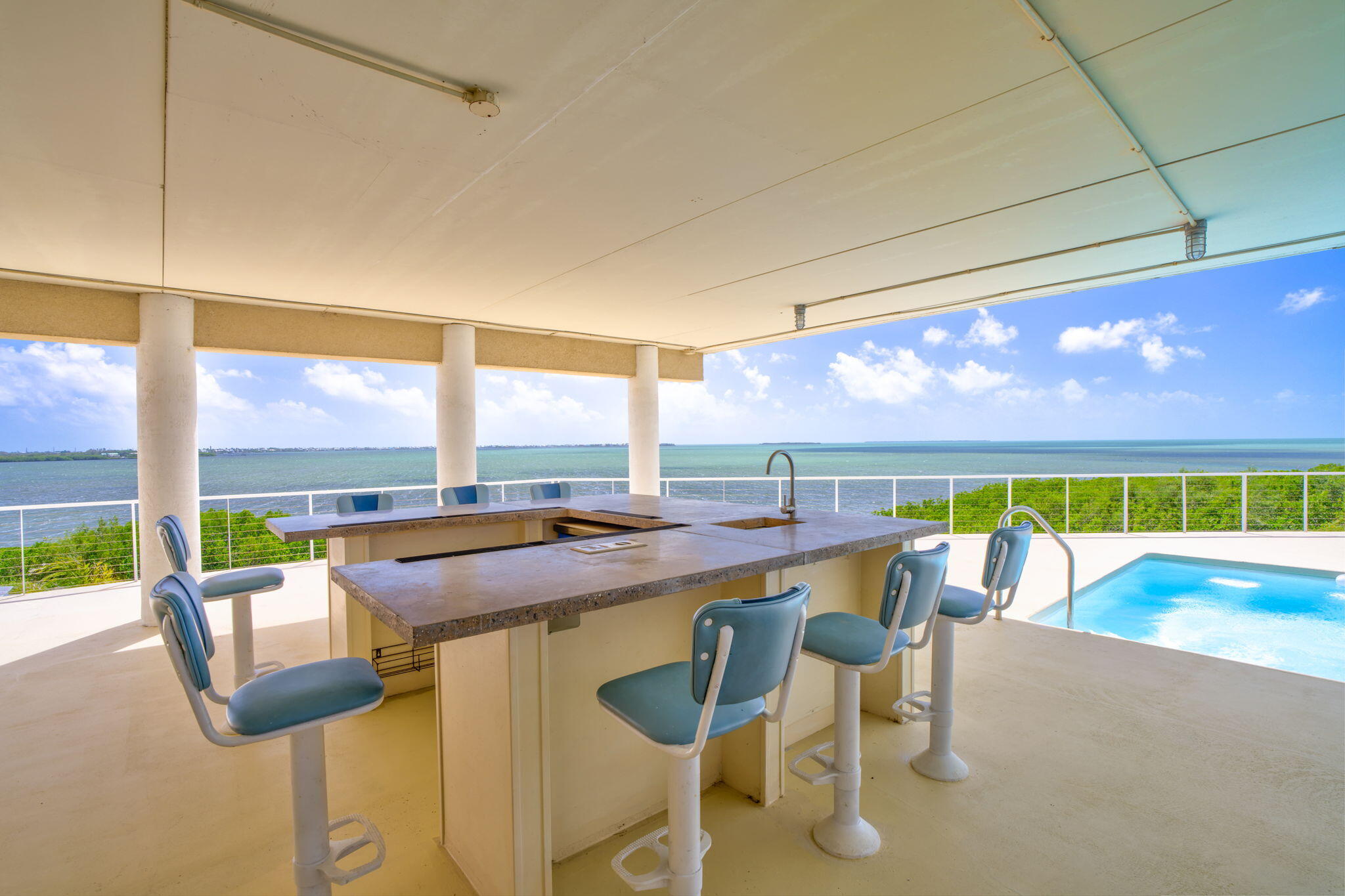 225 Colson Drive Cudjoe, FL 33042 - Photo 32 of 71 a dining room with furniture and a floor to ceiling window