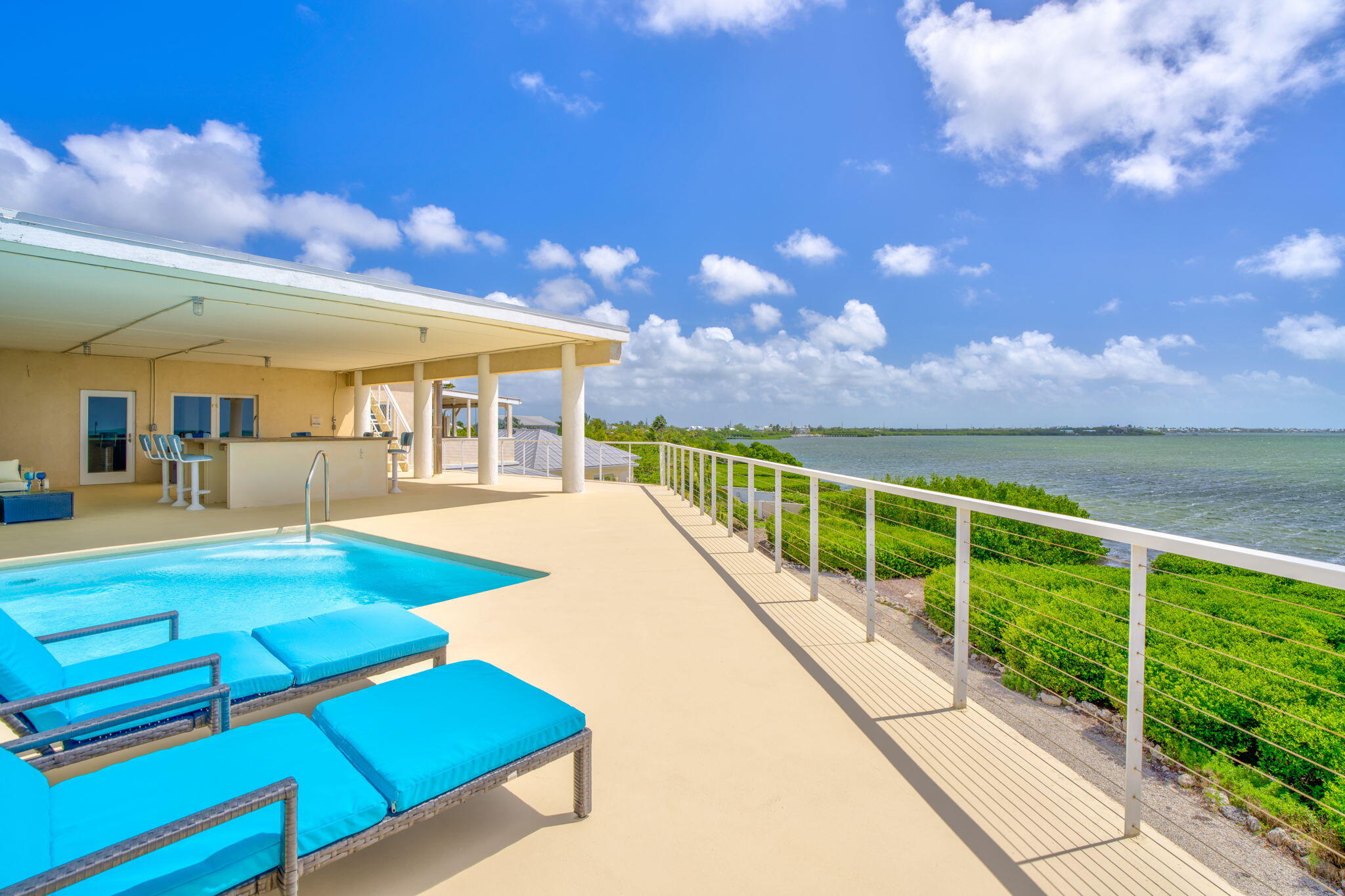 225 Colson Drive Cudjoe, FL 33042 - Photo 33 of 71 a view of swimming pool with a table and chairs