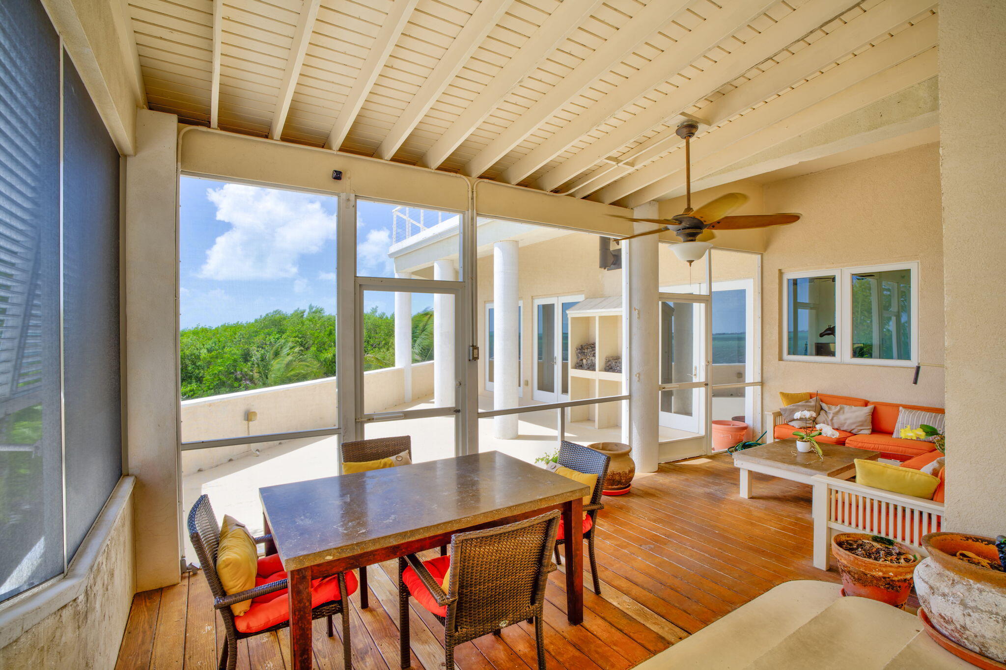 225 Colson Drive Cudjoe, FL 33042 - Photo 45 of 71 a dining room with furniture a chandelier and wooden floor