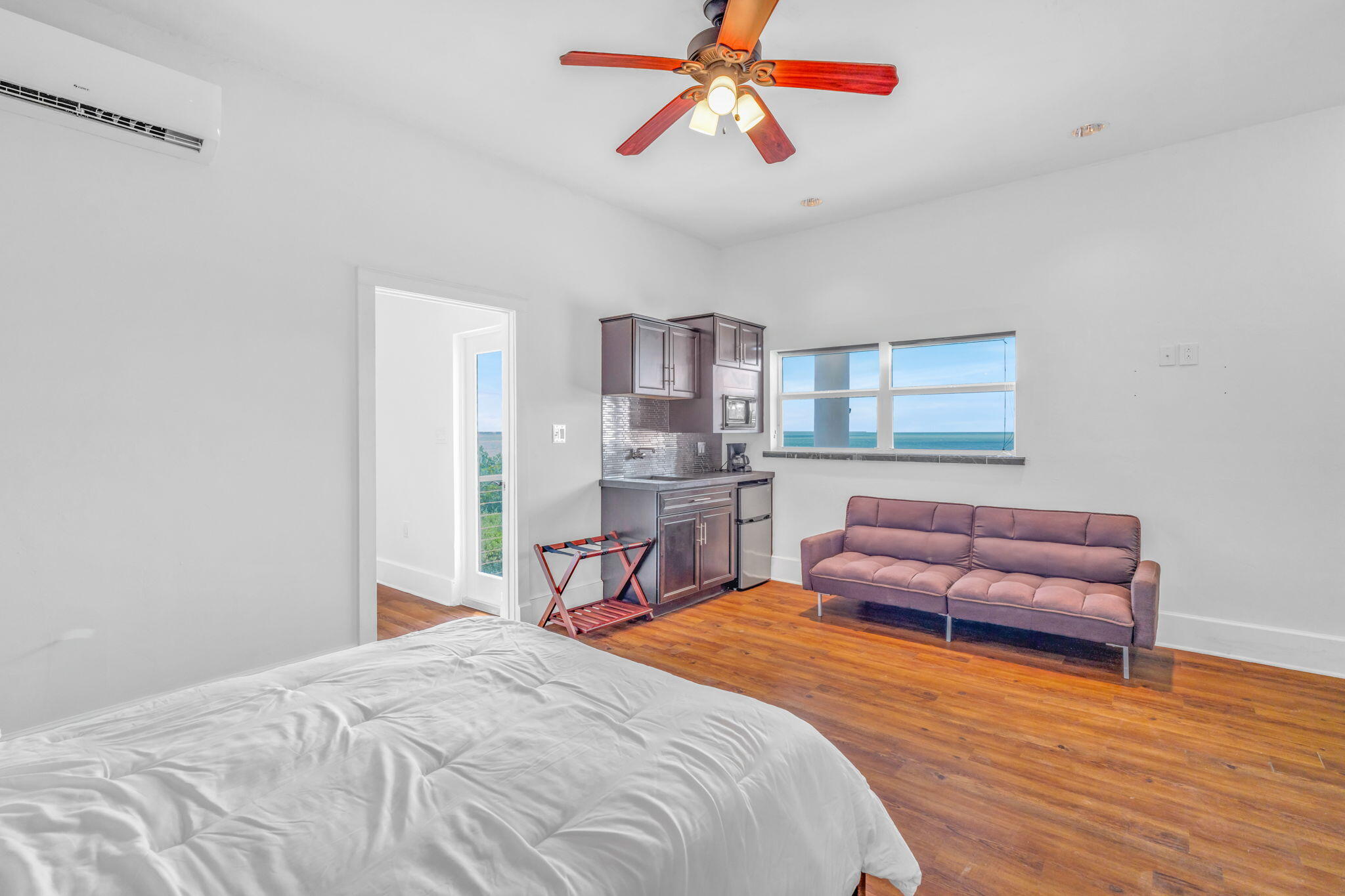 225 Colson Drive Cudjoe, FL 33042 - Photo 48 of 71 a bedroom with a bed and wooden floor