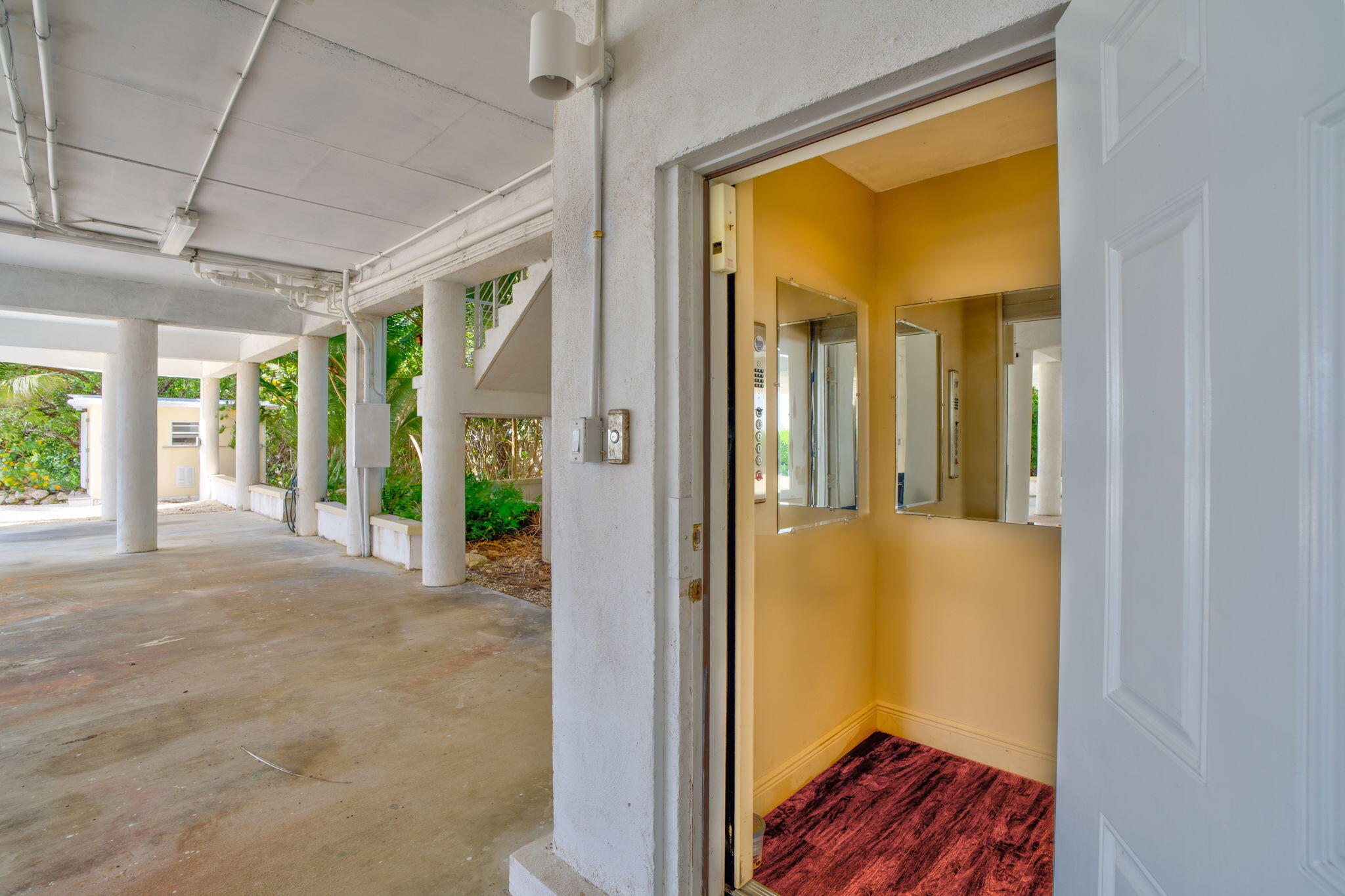 225 Colson Drive Cudjoe, FL 33042 - Photo 56 of 71 a view of a hallway with wooden floor and a livingroom view
