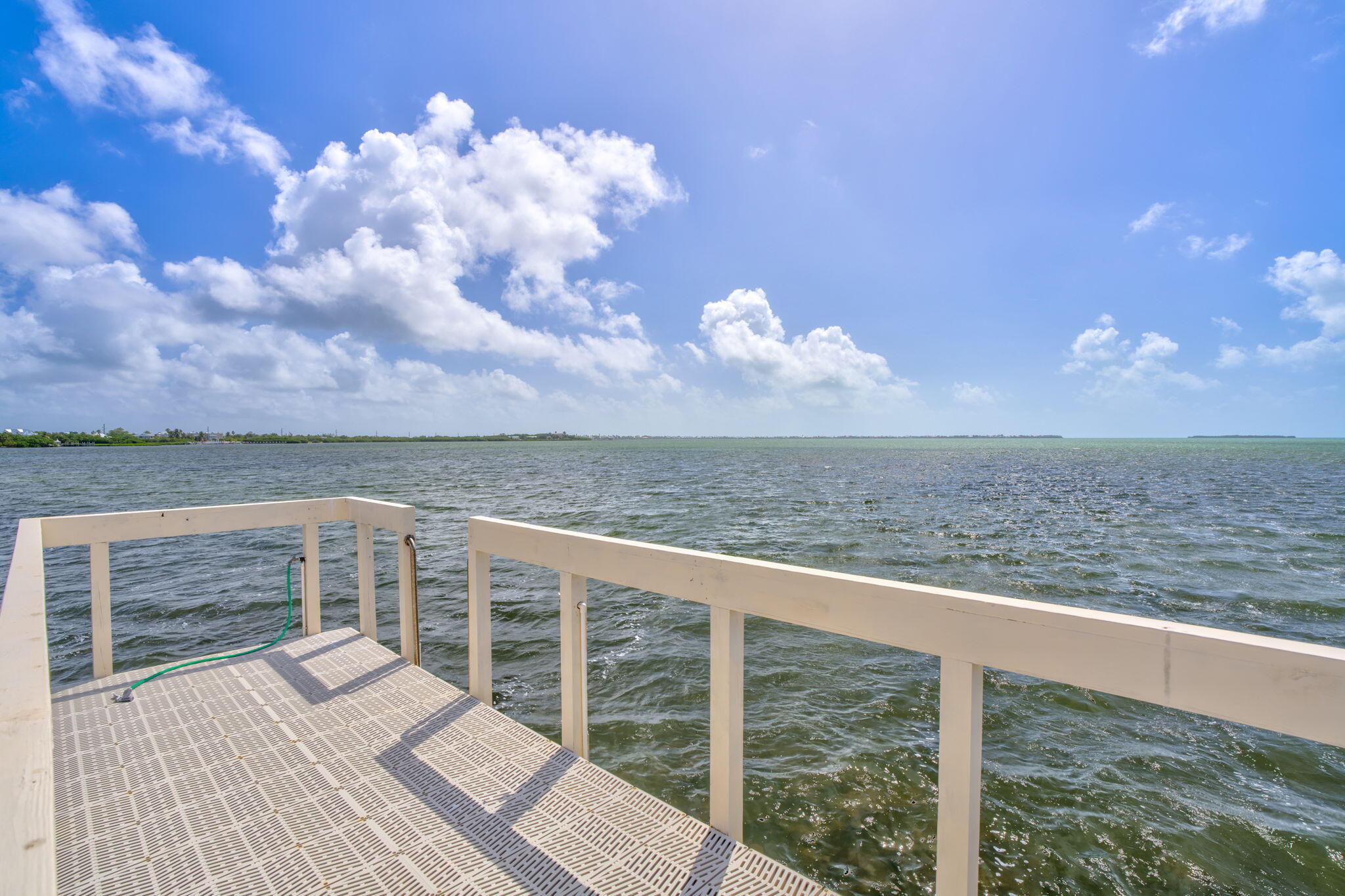 225 Colson Drive Cudjoe, FL 33042 - Photo 61 of 71 a view of a balcony with wooden floor and fence