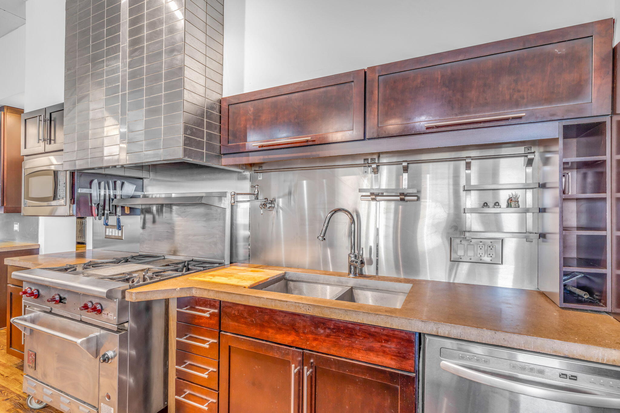 225 Colson Drive Cudjoe, FL 33042 - Photo 10 of 71 a kitchen with kitchen island granite countertop a sink a stove and cabinets