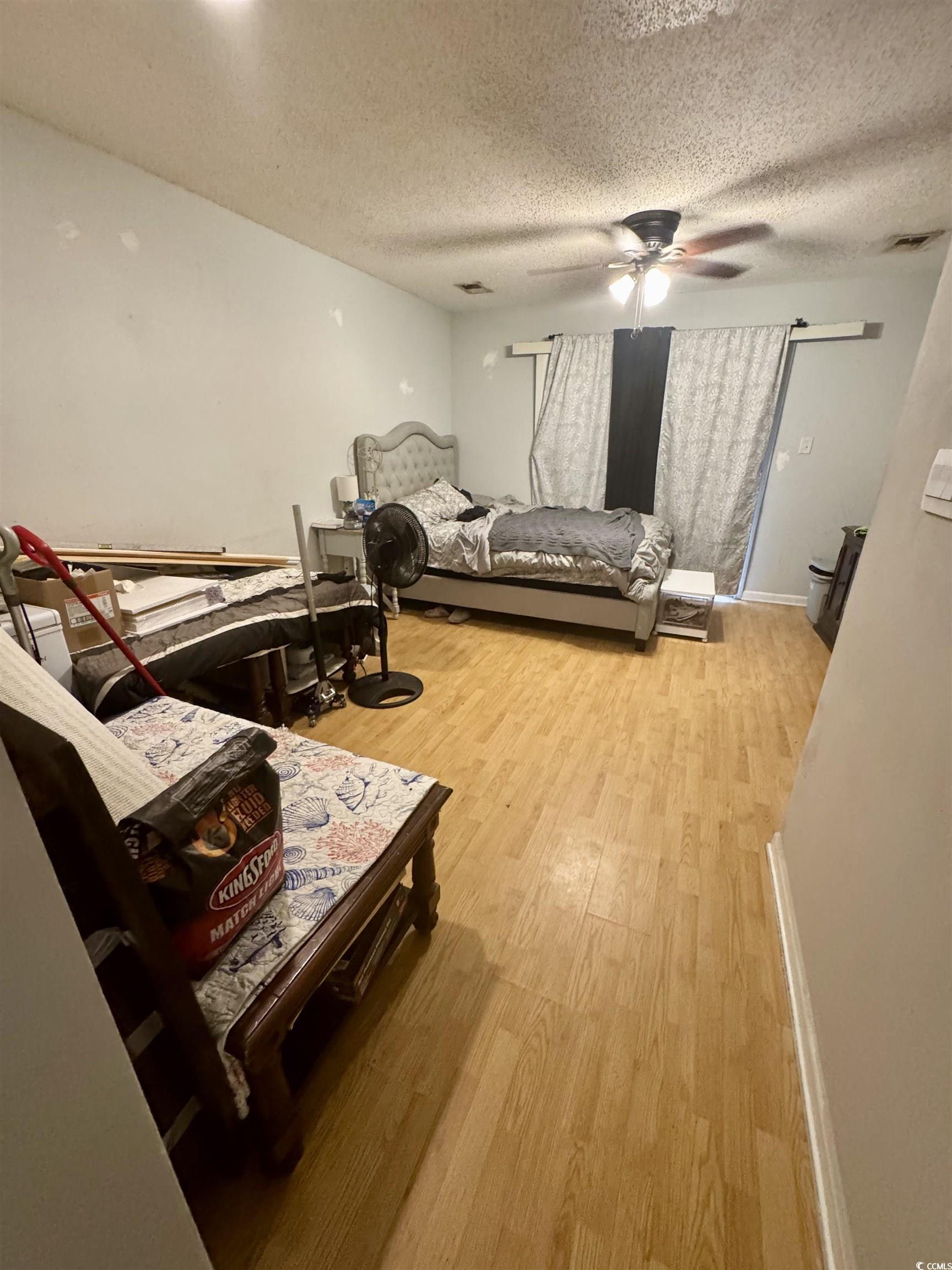 1207 Pinegrove Drive, Unit B Myrtle Beach, SC 29577 - Photo 5 of 16 Bedroom with light wood-style floors, a textured ceiling, and ceiling fan