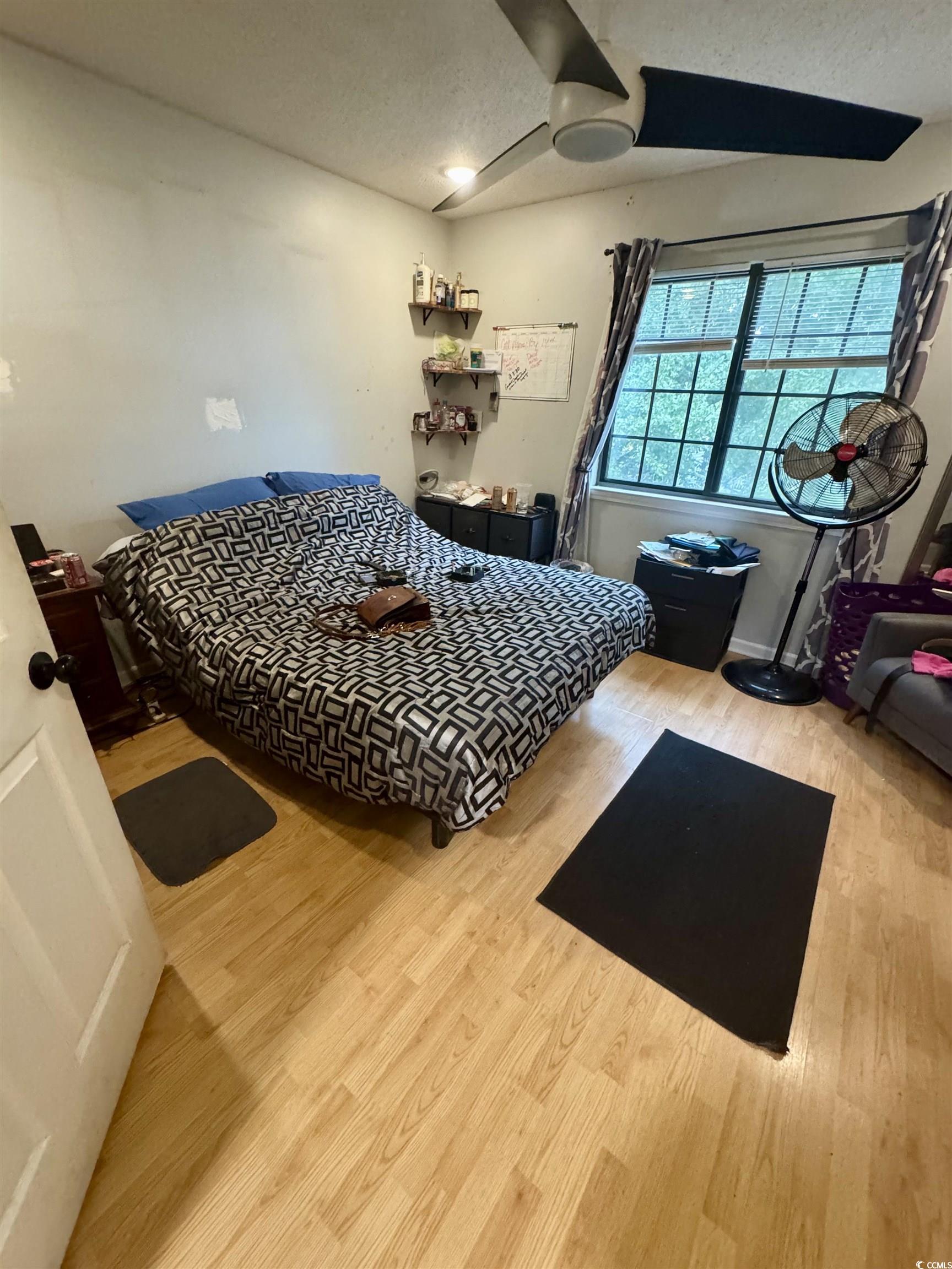 1207 Pinegrove Drive, Unit B Myrtle Beach, SC 29577 - Photo 10 of 16 Bedroom with wood finished floors and a textured ceiling