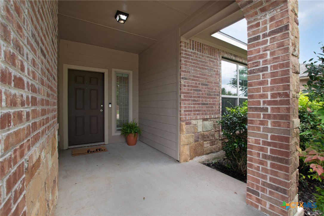 408 Copper Ridge Loop Temple, TX 76502 - Photo 11 of 39 Covered entryway featuring classic brick and stone accents