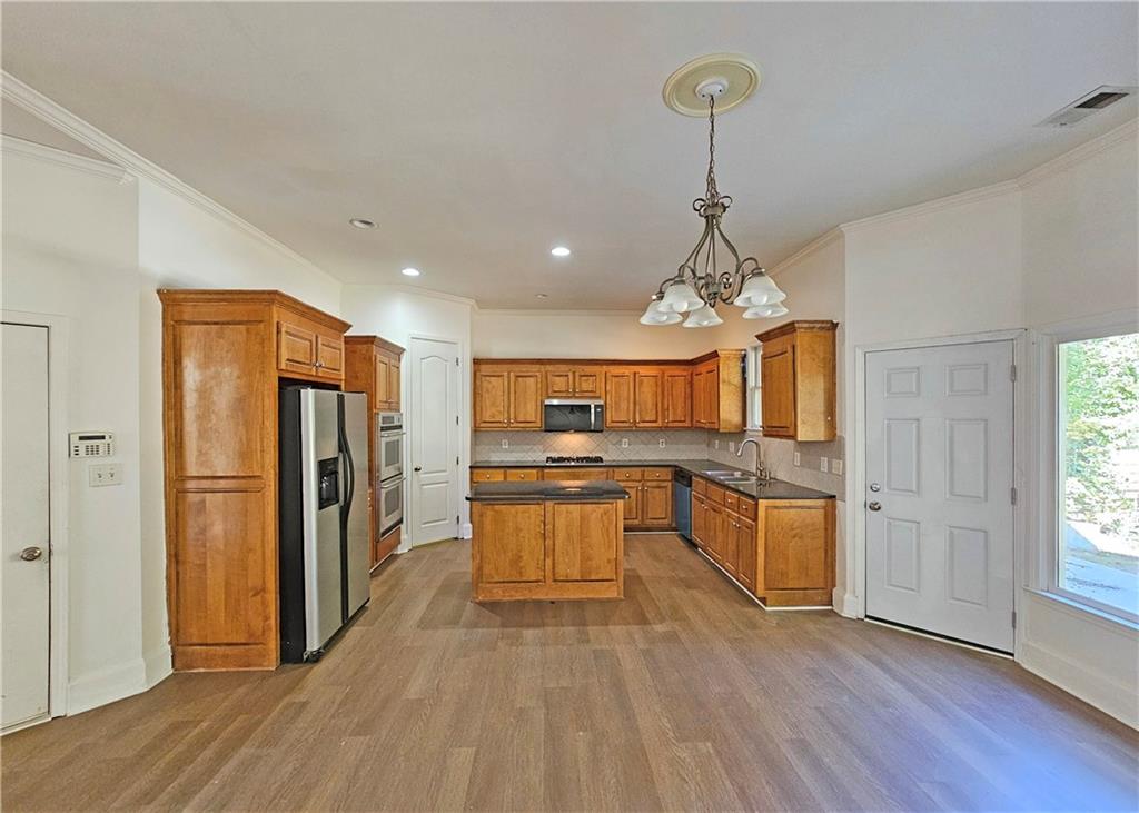 195 Beracah Walk Atlanta, GA 30331 - Photo 12 of 32 a kitchen with stainless steel appliances granite countertop a refrigerator oven a sink dishwasher and a refrigerator with wooden floor