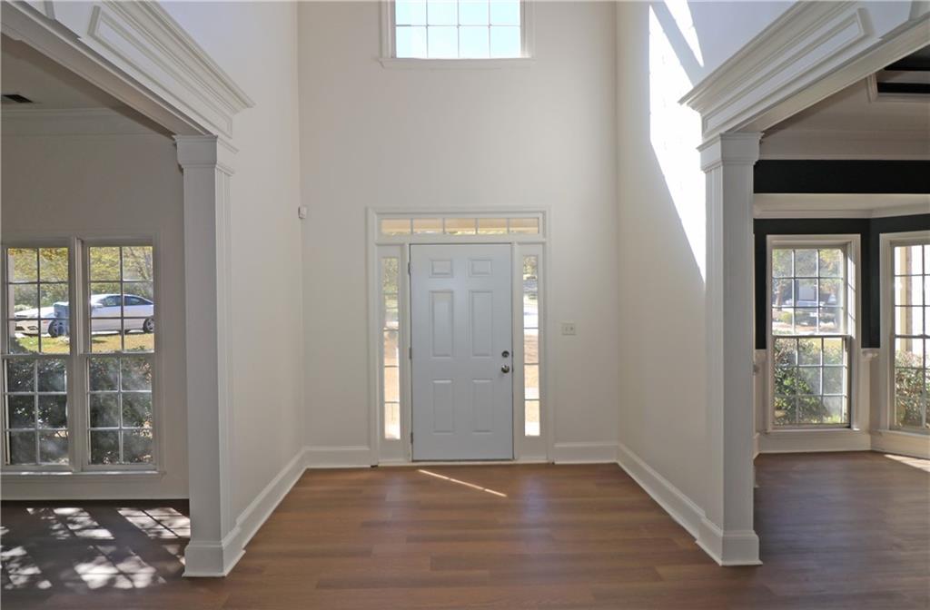 195 Beracah Walk Atlanta, GA 30331 - Photo 3 of 32 a view of an empty room with wooden floor and a window