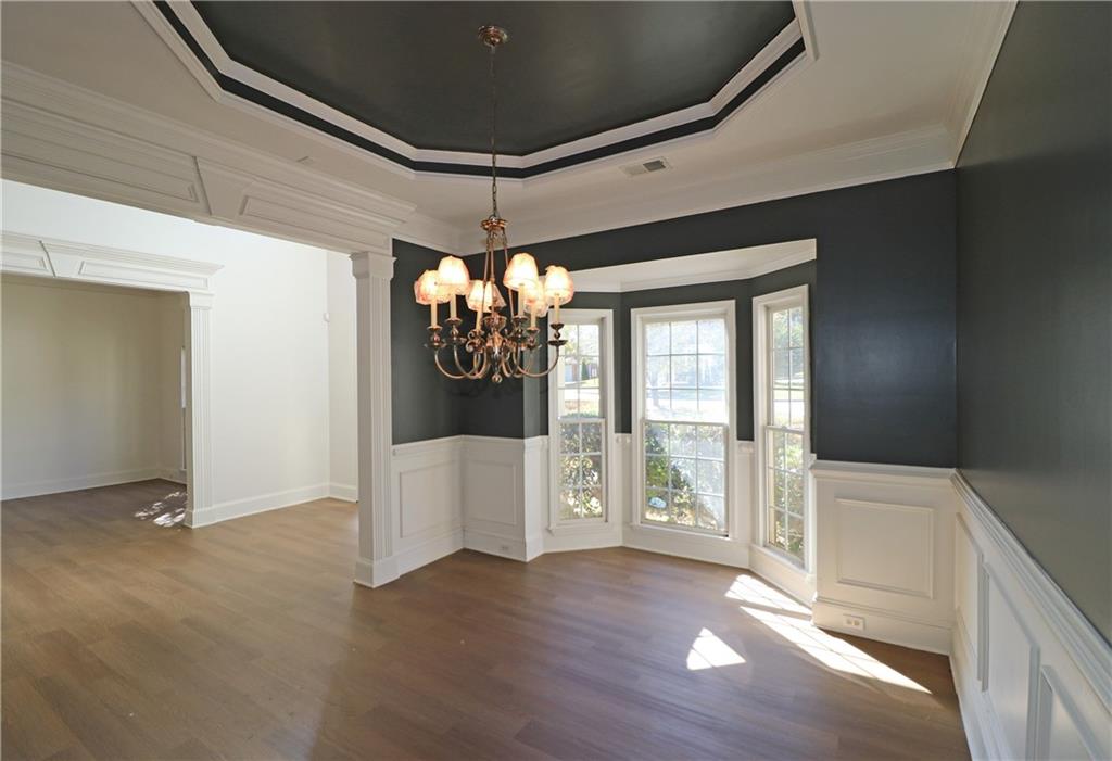 195 Beracah Walk Atlanta, GA 30331 - Photo 10 of 32 a view of an empty room with wooden floor and a window