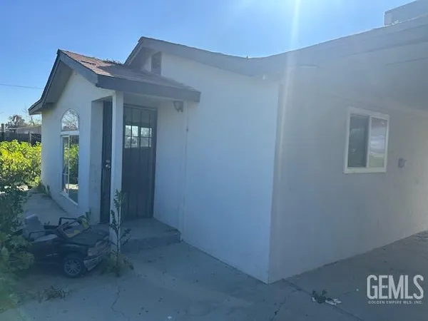 a view of a hallway with wooden floor and a living room