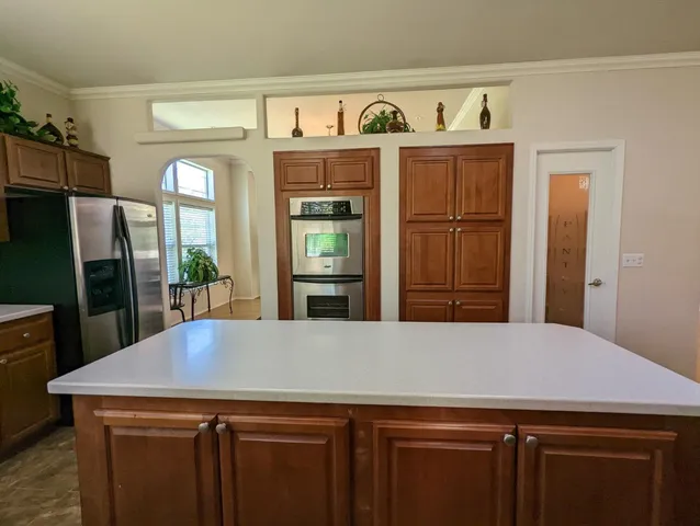 a kitchen with stainless steel appliances a refrigerator and a stove