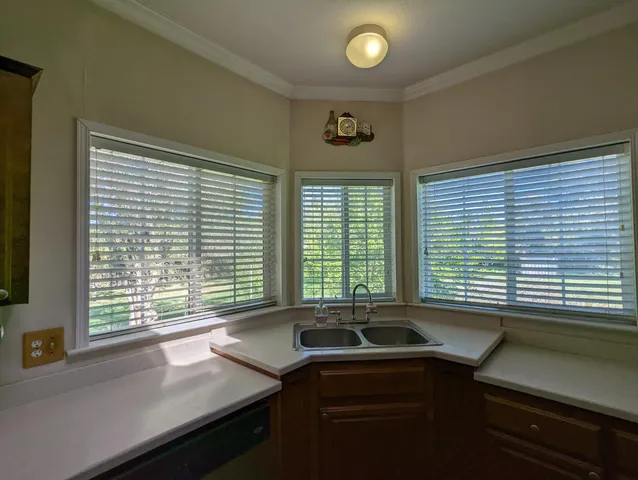 a kitchen with a sink and large window