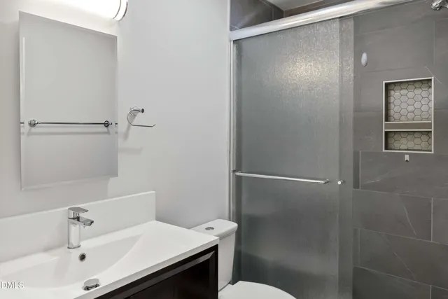 a bathroom with a sink mirror and toilet