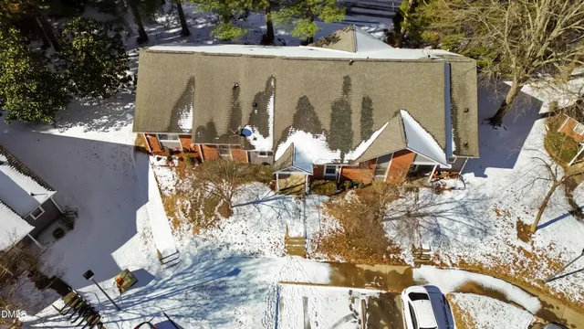 an aerial view of a house with swimming pool and sitting area