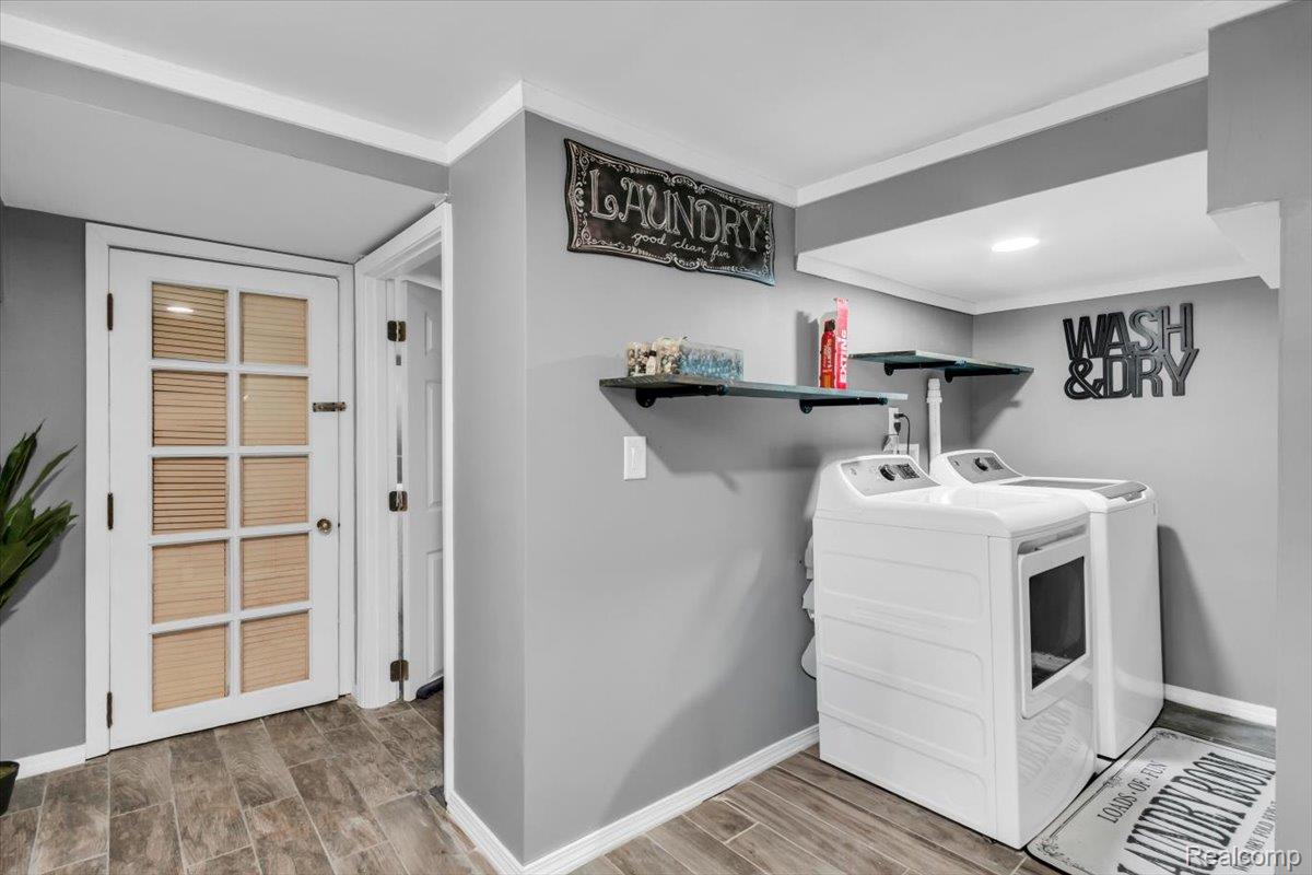 476 Touraine Road Grosse Pointe, MI 48236 - Photo 24 of 30 Laundry area featuring wood-look tile flooring, light gray wall paint, white crown molding, and recessed lighting