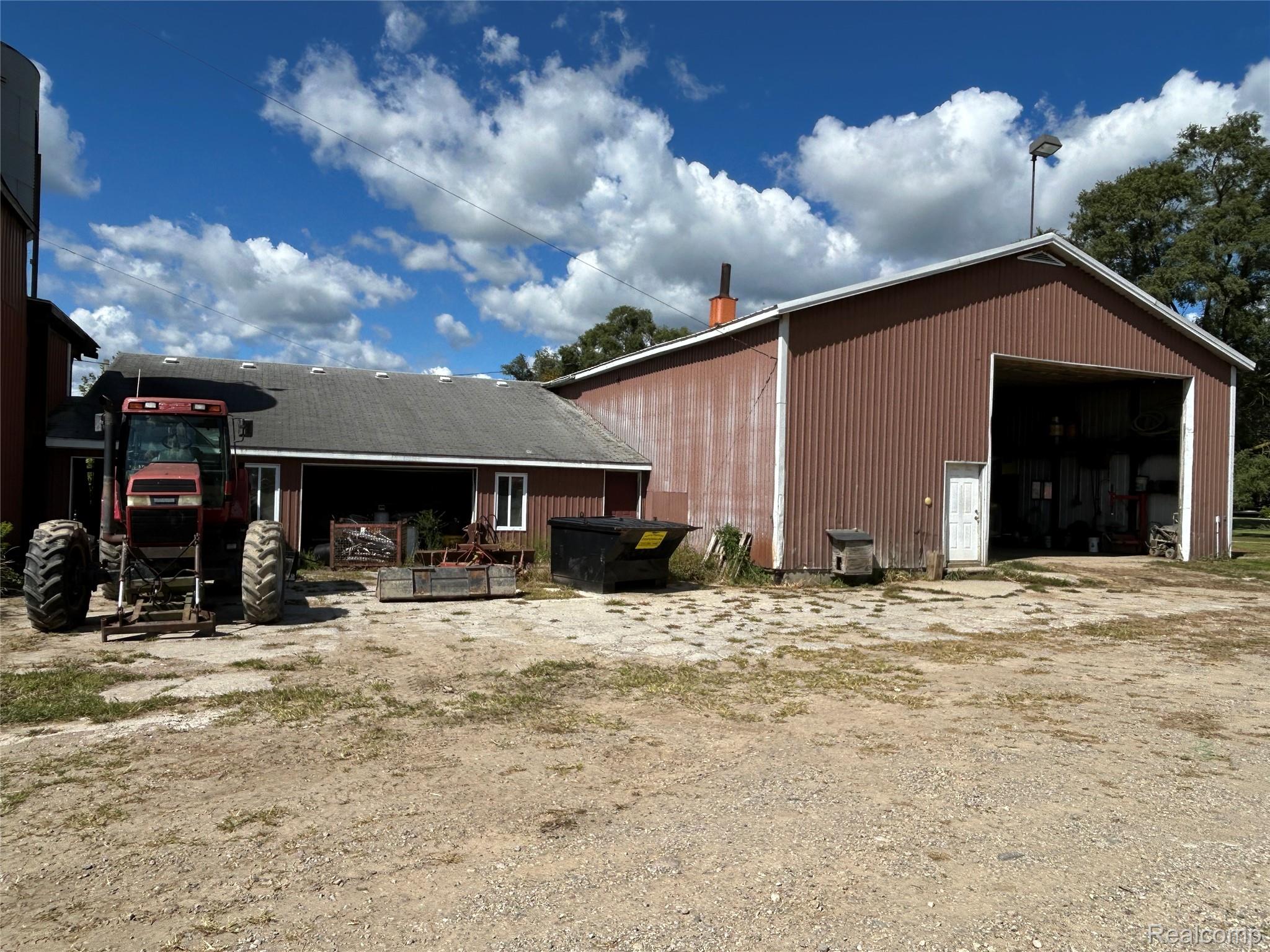 16465 Almont Road Allenton, MI 48002 - Photo 34 of 35 Red corrugated metal barn with a white trim