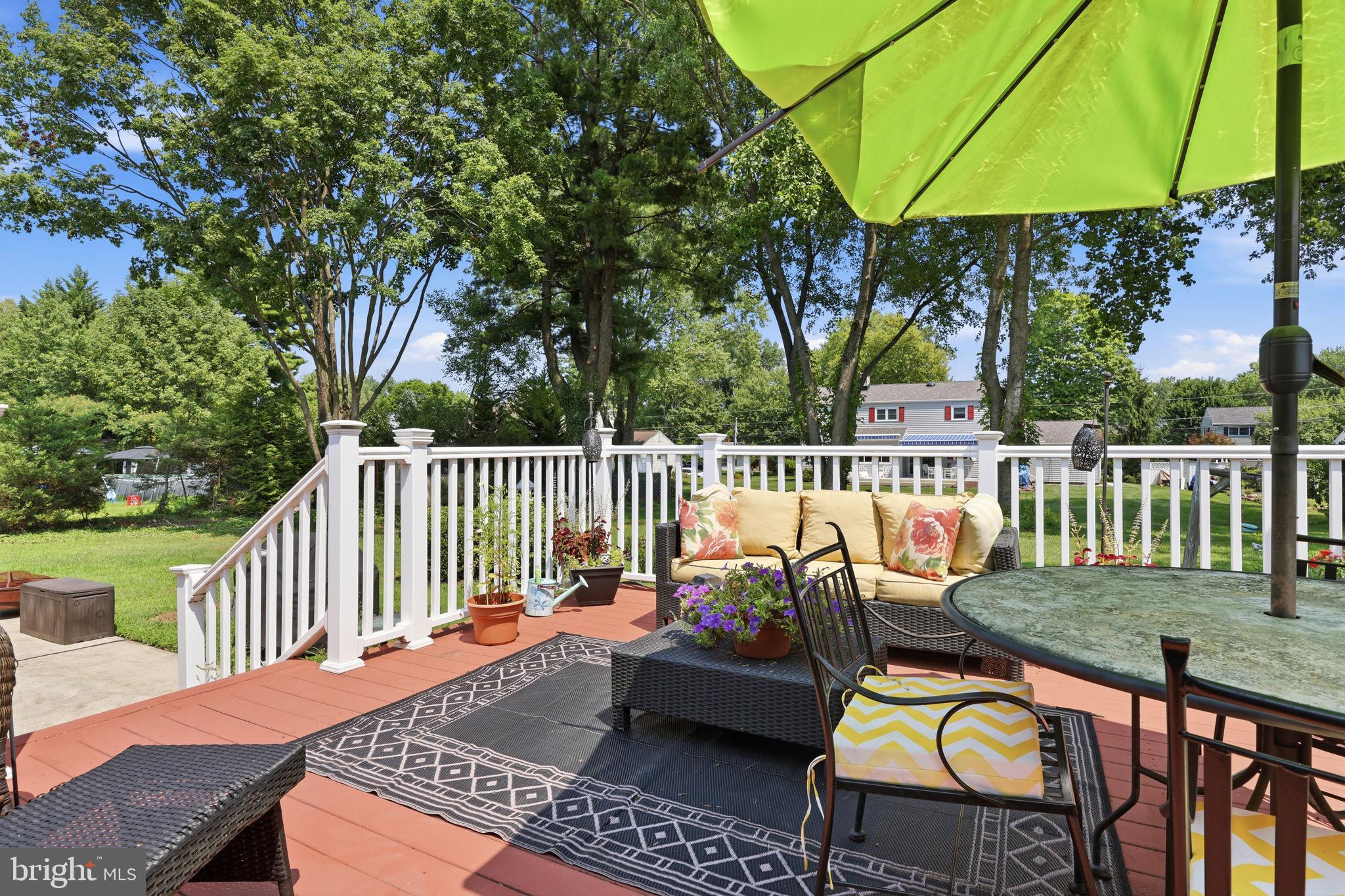 298 Hickory Road Yardley, PA 19067 - Photo 34 of 48 Sunny deck with vibrant greenery.